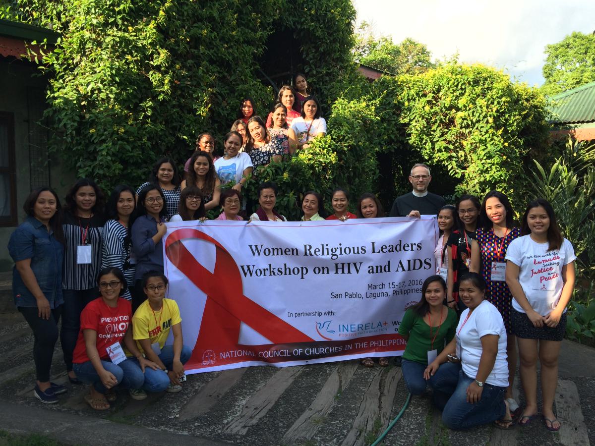 Women religious leaders behind a banner for the workshop on HIV and AIDS, San Pablo, Laguna, March 2016